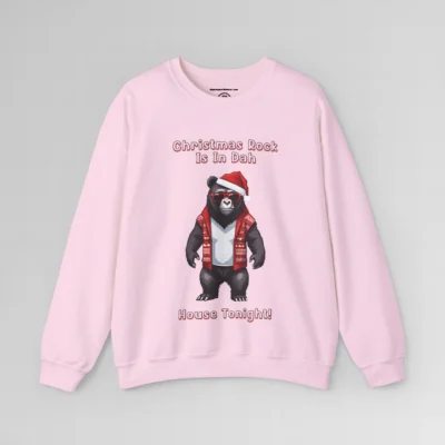 A pink sweatshirt with a slightly pixelated Big Baby Gorilla Bear Mascot image in a Christmas sweater, with a Santa hat on, with words in 3-D font that say "Christmas Rock Is In Dah House Tonight!