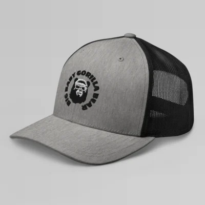 Left side view of a Heather Black mesh trucker cap, with the Big Baby Gorilla Bear mascot's face and the Big Baby Gorilla Bear Name encircling the face, Embroidered in black and white on the front of the cap.