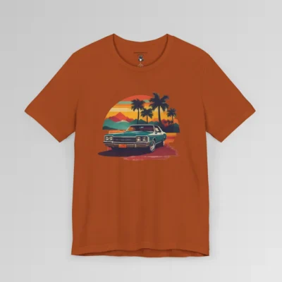 Front of a t-shirt with retro colors of orange, blues, browns, and yellows showing a classic blue-teal car, with palm trees, mountains, and a sky with the sun going down. Autumn colored shirt.