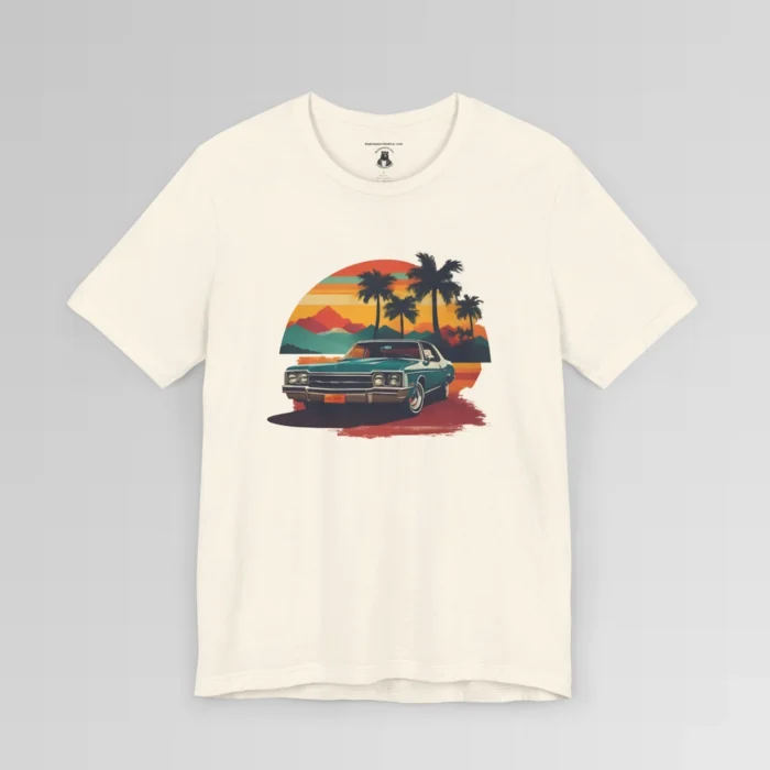Front of a t-shirt with retro colors of orange, blues, browns, and yellows showing a classic blue-teal car, with palm trees, mountains, and a sky with the sun going down. Natural colored shirt.