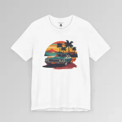 Front of a t-shirt with retro colors of orange, blues, browns, and yellows showing a classic blue-teal car, with palm trees, mountains, and a sky with the sun going down. White colored shirt.