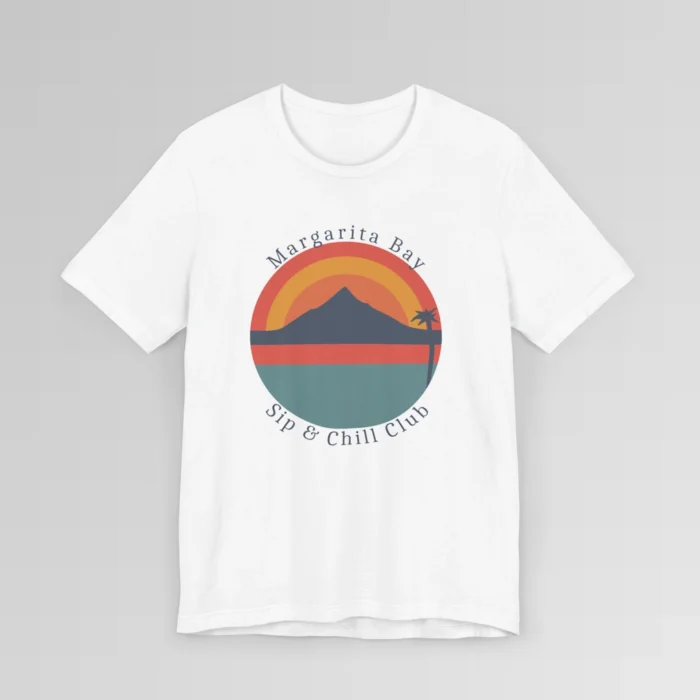 A white colored t-shirt mockup (front) with a circular, minimalistic design of water, sky, mountains, and a palm tree. The colors are orange, yellow, deep blue, and blue. The tee has the words "Margarita Bay" and "Sip & Chill Club" wrapped around the circular design.