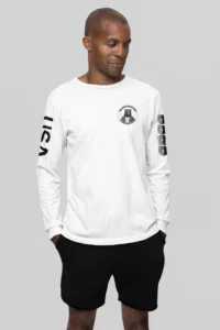 Male model highlighting the front of a white long sleeve tee, with the Big Baby Gorilla Bear Logo on the front, and the letters "USA" and "BBGB" opposite sleeves. The "BBGB" letters has lines going through each letter, adding a trendy blind appearance to the bottom half of the lettering.