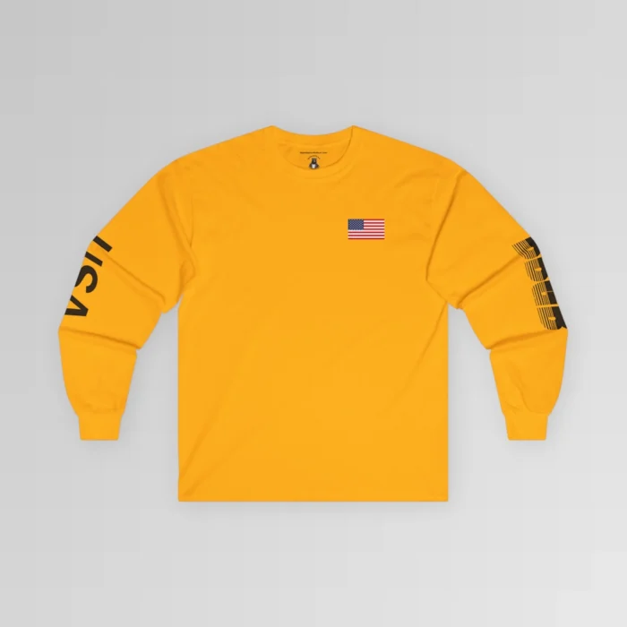 The frontside of the gold colored BBGB USA Full Stack Long Sleeve Tee, with an American Flag on the front left breast section, and the letters "USA" on the right sleeve, and "BBGB" on the left sleeve. The Letters "BBGB" have transparent lines going through the lower portion of the letters.