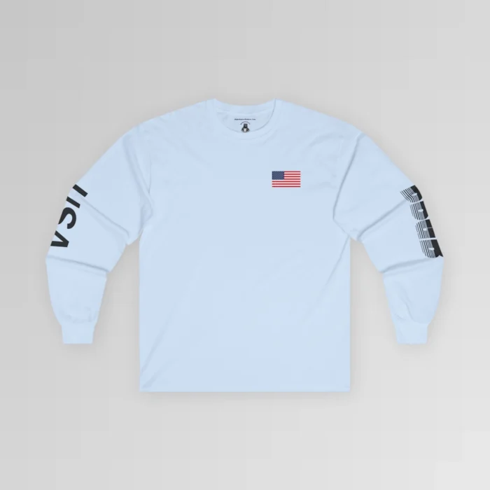 The frontside of the light blue colored BBGB USA Full Stack Long Sleeve Tee, with an American Flag on the front left breast section, and the letters "USA" on the right sleeve, and "BBGB" on the left sleeve. The Letters "BBGB" have transparent lines going through the lower portion of the letters.