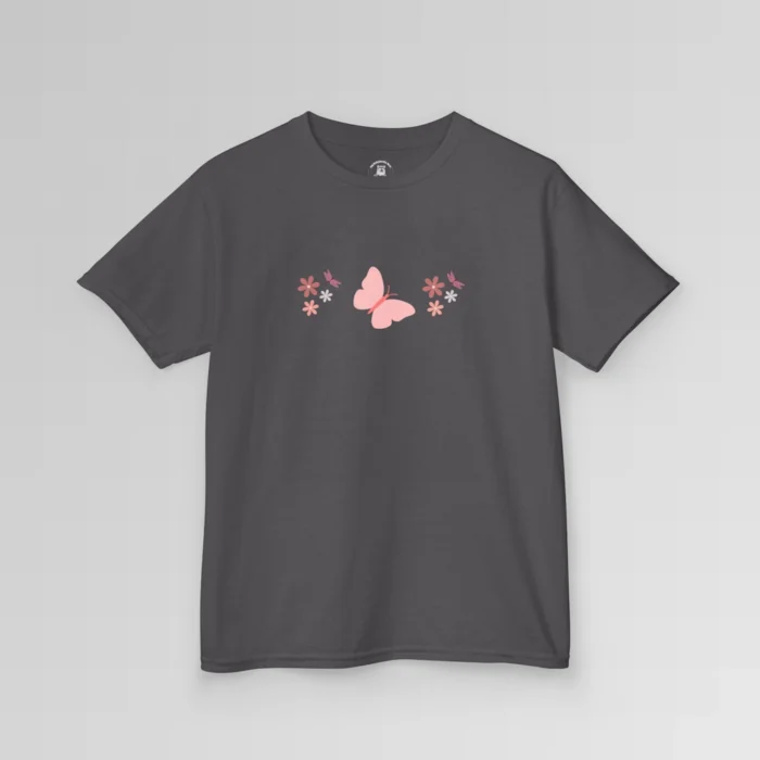 A charcoal colored shirt with a pink butterfly with a coral-colored body in the center, and pink, white, and blush colored flowers, and blush colored dragonflies...in a pattern going vertically across the tee. Child's Version.