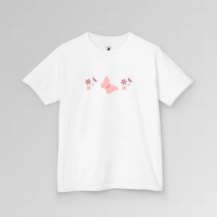 A white colored shirt with a pink butterfly with a coral-colored body in the center, and pink, white, and blush colored flowers, and blush colored dragonflies...in a pattern going vertically across the tee. Child's Version.