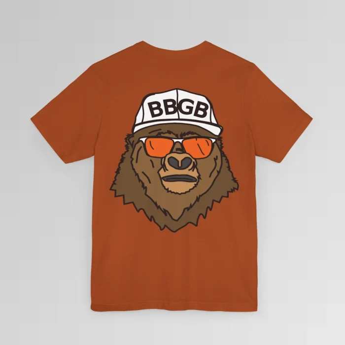 The back of a autumn colored shirt, with the Big Baby Gorilla Bear Mascot's face, wearing a white ball cap, and orange and white shades, super imposed on the back of a tee shirt.