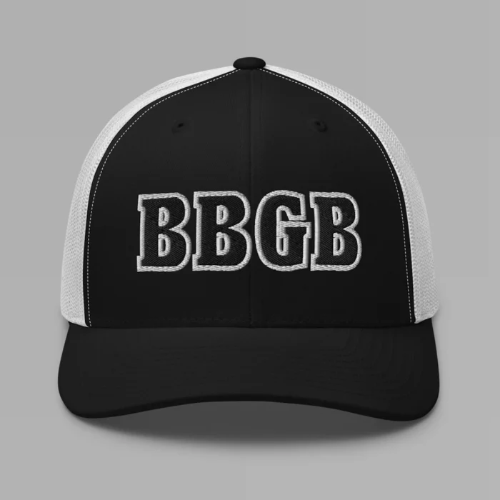 A black and white hat with the letters "BBGB" embroidered on the front in black thread, with a white border, on a trucker cap with a mesh back.