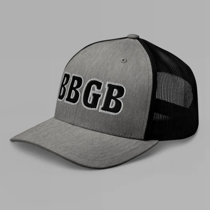 A heather and black hat with the letters "BBGB" embroidered on the front in black thread, with a white border, on a trucker cap with a mesh back. (Left Side View)