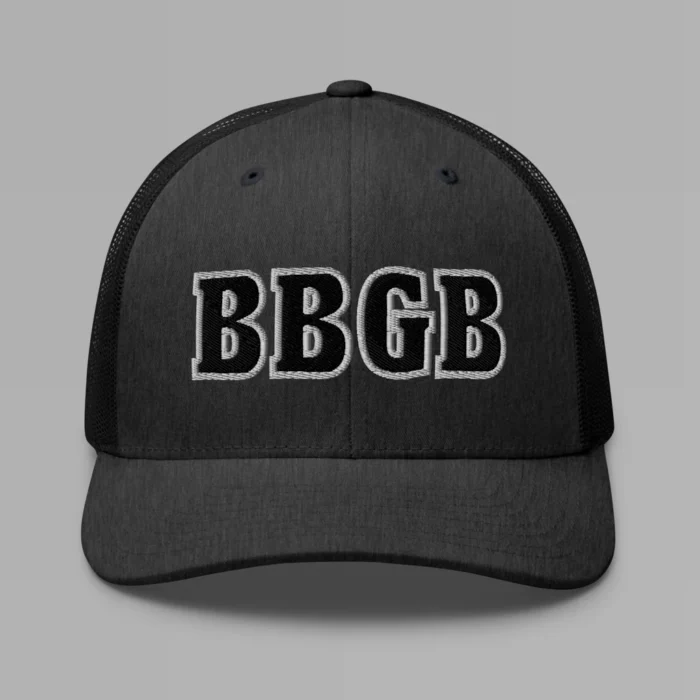 A dark heather grey hat with the letters "BBGB" embroidered on the front in black thread, with a white border, on a trucker cap with a mesh back.