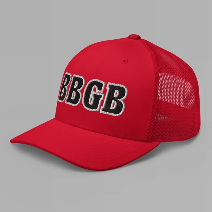 A red hat with the letters "BBGB" embroidered on the front in black thread, with a white border, on a trucker cap with a mesh back. (Left Side View)