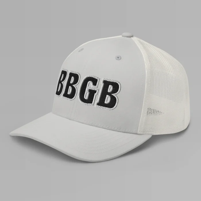 A silver hat with the letters "BBGB" embroidered on the front in black thread, with a white border, on a trucker cap with a mesh back. (Left Side View)