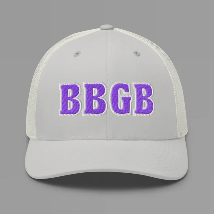 A silver hat with the letters "BBGB" embroidered on the front in purple thread, with a white border, on a trucker cap with a mesh back.