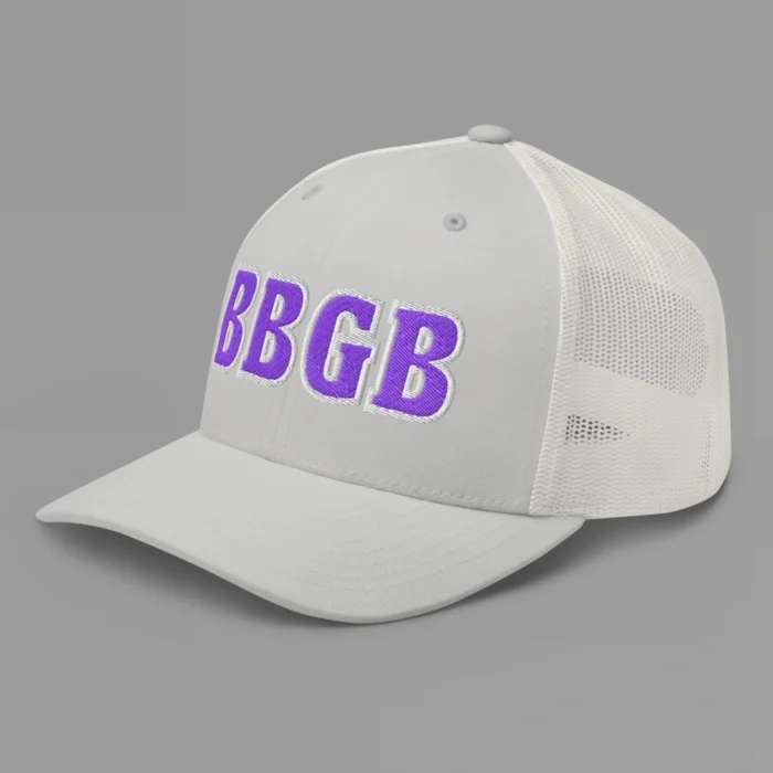 A silver hat with the letters "BBGB" embroidered on the front in purple thread, with a white border, on a trucker cap with a mesh back. (Left Side View)