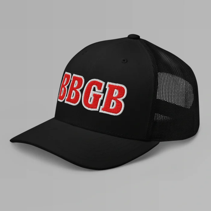 A white hat with the letters "BBGB" embroidered on the front in red thread, with a white border, on a trucker cap with a mesh back. (Left Side View)