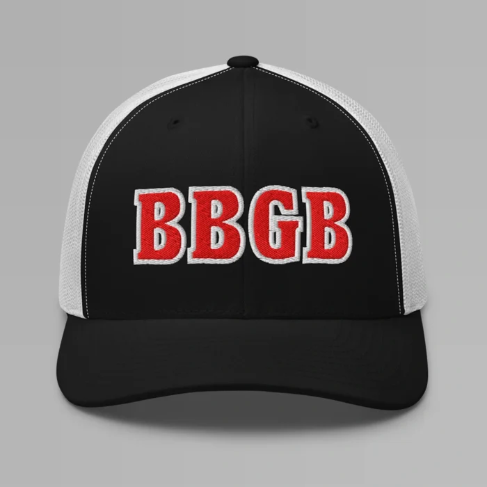 A black and white hat with the letters "BBGB" embroidered on the front in red thread, with a white border, on a trucker cap with a mesh back.