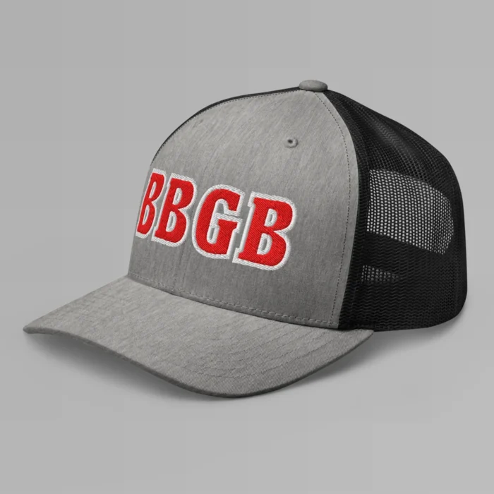 A heather and black hat with the letters "BBGB" embroidered on the front in red thread, with a white border, on a trucker cap with a mesh back. (Left Side View)