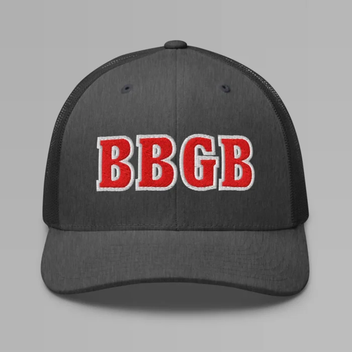 A dark heather grey hat with the letters "BBGB" embroidered on the front in red thread, with a white border, on a trucker cap with a mesh back.