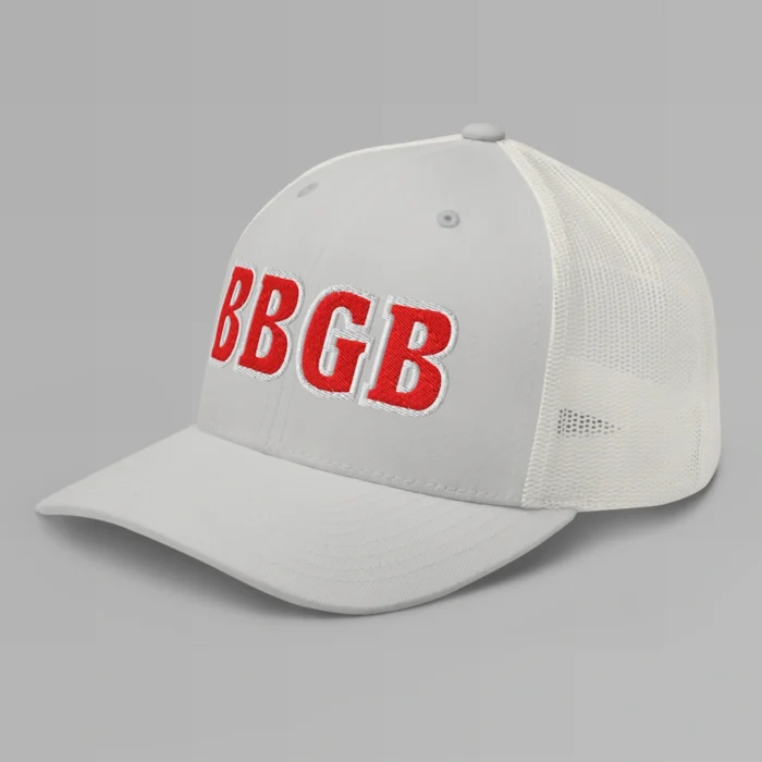 A silver hat with the letters "BBGB" embroidered on the front in red thread, with a white border, on a trucker cap with a mesh back. (Left Side View)