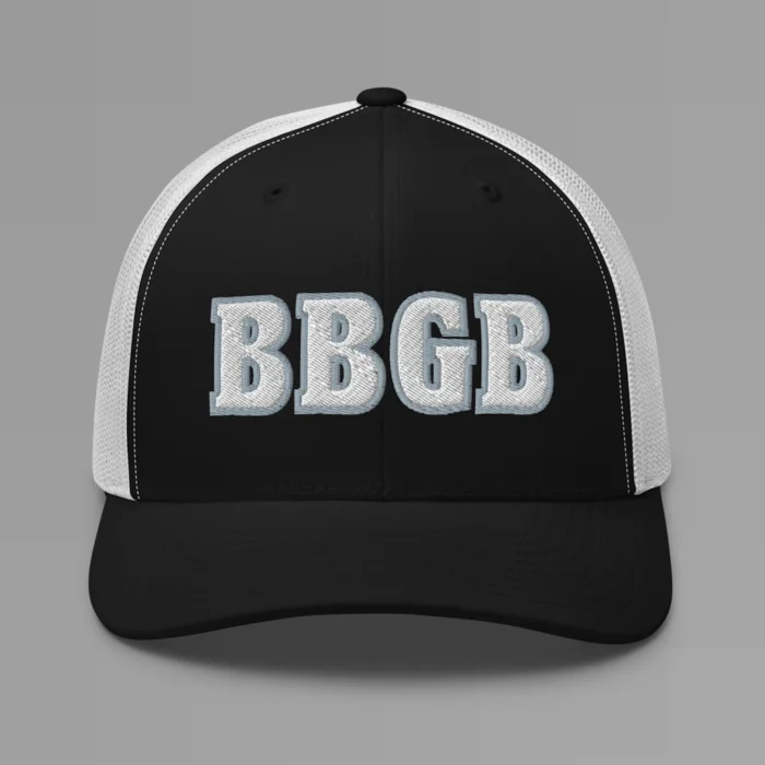 A black and white hat with the letters "BBGB" embroidered on the front in white thread, with a silver border, on a trucker cap with a mesh back.