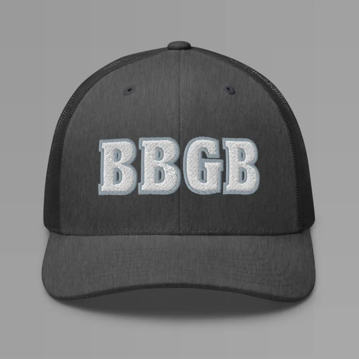 A dark heather grey hat with the letters "BBGB" embroidered on the front in white thread, with a silver border, on a trucker cap with a mesh back.