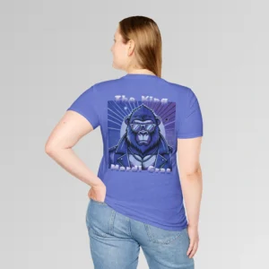 Female model in heather royal t-shirt showing the back of a tee with a deep purple graphic of a swag looking gorilla bear character, wearing shades, with a sun behind it, in a retro style, and the words "The King" and "Mardi Gras" in a gradient colored yellow to green font.