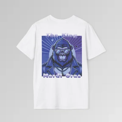 The backside of a white colored tee with a swag looking gorilla bear wearing shades, with a sun like object with rays shooting out from behind the character. The words "The King" are above the graphic, and "Mardi Gras" beneath the graphic. The entire image is in varying shades of purple.