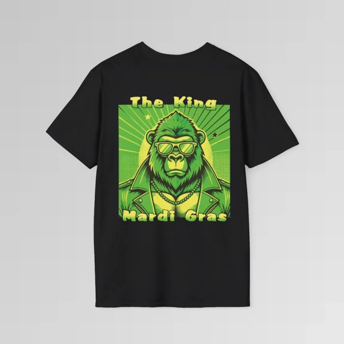 The backside of a black colored tee with a swag looking gorilla bear wearing shades, with a sun like object with rays shooting out from behind the character. The words "The King" are above the graphic, and "Mardi Gras" beneath the graphic. The entire image is in varying shades of green and gold.