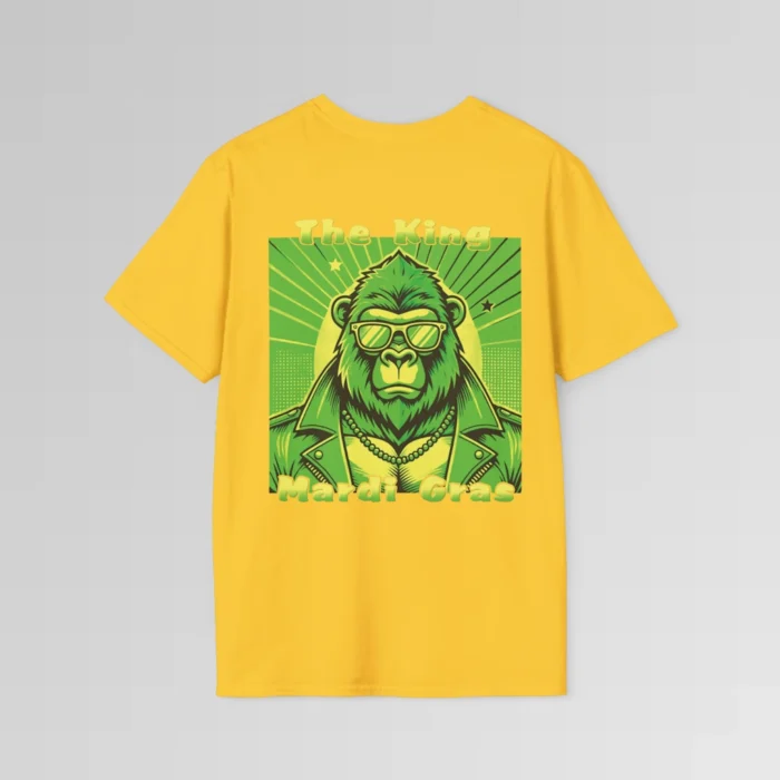 The backside of a gold colored tee with a swag looking gorilla bear wearing shades, with a sun like object with rays shooting out from behind the character. The words "The King" are above the graphic, and "Mardi Gras" beneath the graphic. The entire image is in varying shades of green and gold.