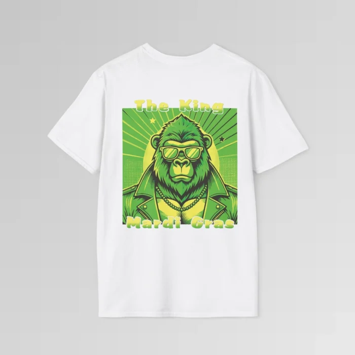 The backside of a white colored tee with a swag looking gorilla bear wearing shades, with a sun like object with rays shooting out from behind the character. The words "The King" are above the graphic, and "Mardi Gras" beneath the graphic. The entire image is in varying shades of green and gold.