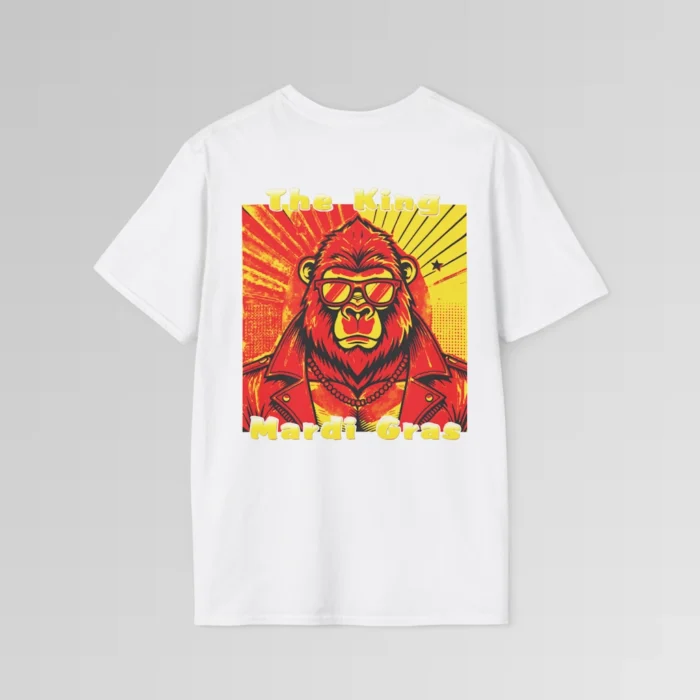 The backside of a white colored tee with a swag looking gorilla bear wearing shades, with a sun like object with rays shooting out from behind the character. The words "The King" are above the graphic, and "Mardi Gras" beneath the graphic. The entire image is in varying shades of red, yellow, and orange.