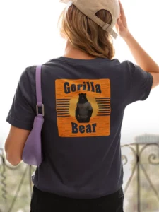Female model showcasing the back of the Gorilla Bear Sunset Graphic Tee - navy.