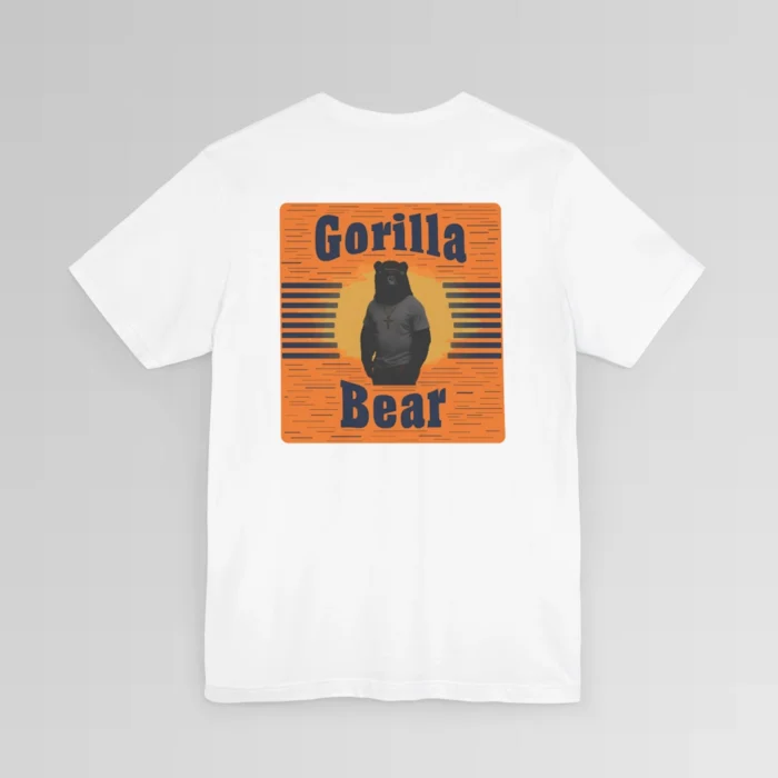 An orange and dark navy colored rectangular design on the back of a Big Baby Gorilla Bear Tee. Our Gorilla Bear Mascot Silhouette is in front of an orange and yellow sunset, with vertical blue lines on each side. The words "Gorilla" are at the top of the design, and "Bear" is at the bottom of the design. Shirt color - white.