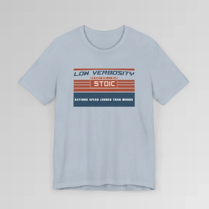 An orange and blue rectangular graphic, block styled", with the words "Low Verbosity", "Big Baby Gorilla Bear", "Stoic", and "Actions Speak Louder Than Words" on the front of the t-shirt. Color; Light Blue.
