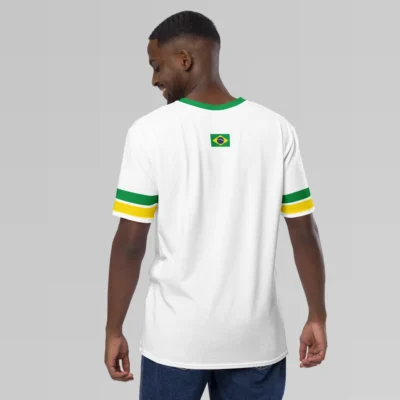 A male model showcasing the backside of the Sao Paulo Brasil Luxurious Tee from BigBabyGorillaBear.Com. This shirt is white, with a green collar, green and yellow sleeve stripes, and a Brazilian flag on the back - top, center.