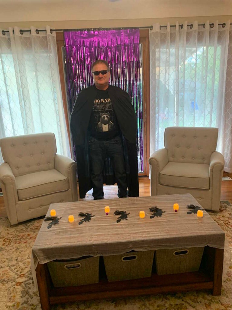 A male in a cape, and a BBGB Retro Styled tee in a Halloween setting.