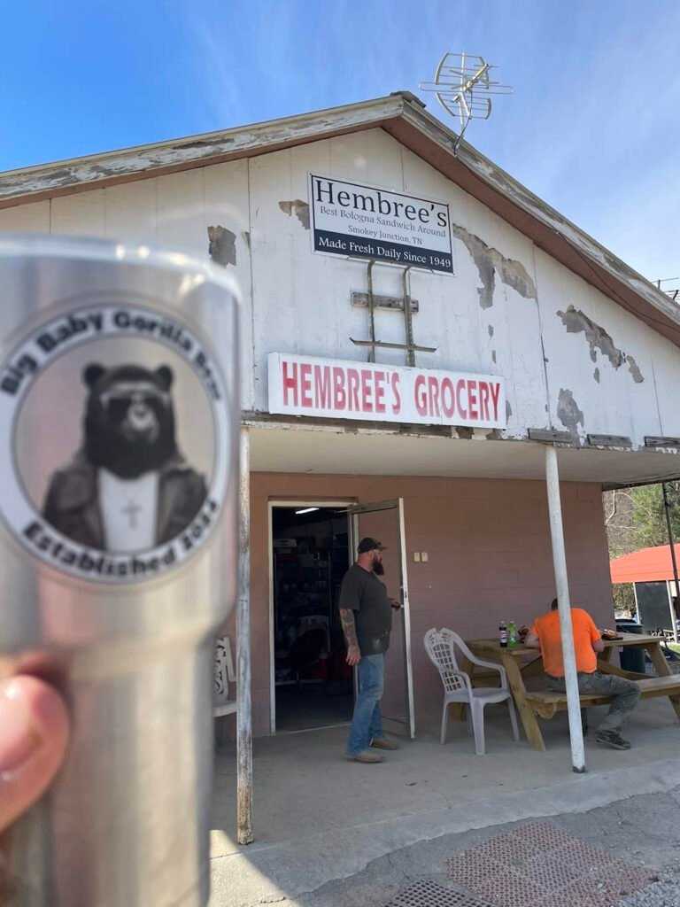 A Big Baby Gorilla Bear Logo sticker on a metal coffee mug outside the famous Hembree's Grocery market in Tennessee.