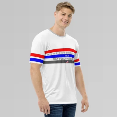 Male model looking straight, angled to the left, smiling and wearing the New York United States Luxurious Tee from BigBabyGorillaBear.Com, on a hanger. The shirt has three bands across the chest (red, blue, and dark grey). Light grey stars span across and in between the red and blue bands. a white "BBGB" is centered inside the blue band. Light grey "New York, United States" is centered between the blue and dark grey bands. in the center of the dark grey band is a small American flag, centered. The sleeves have red and blue stripes, with a black outline.